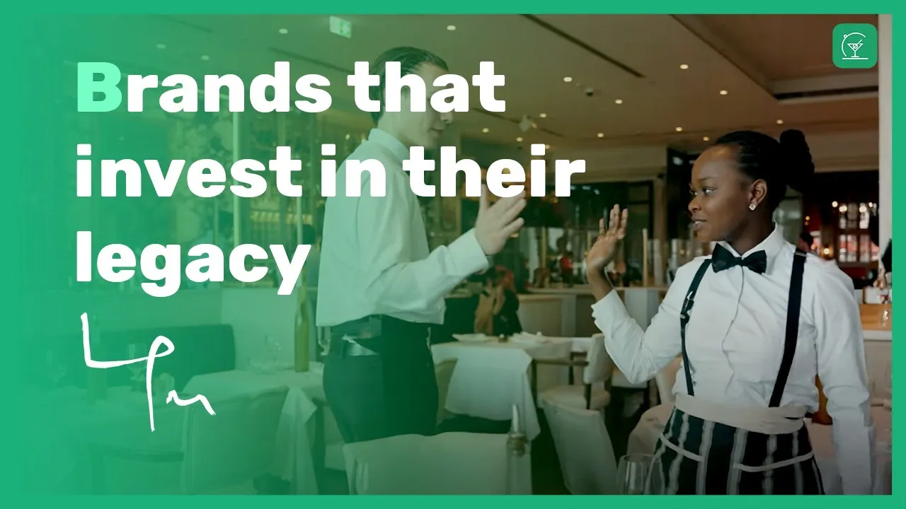 LPM restaurant floor staff in formal black and white uniforms serving guests in the dining room
